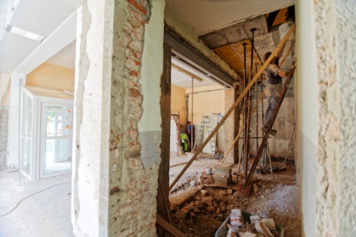 man climbing on ladder inside room