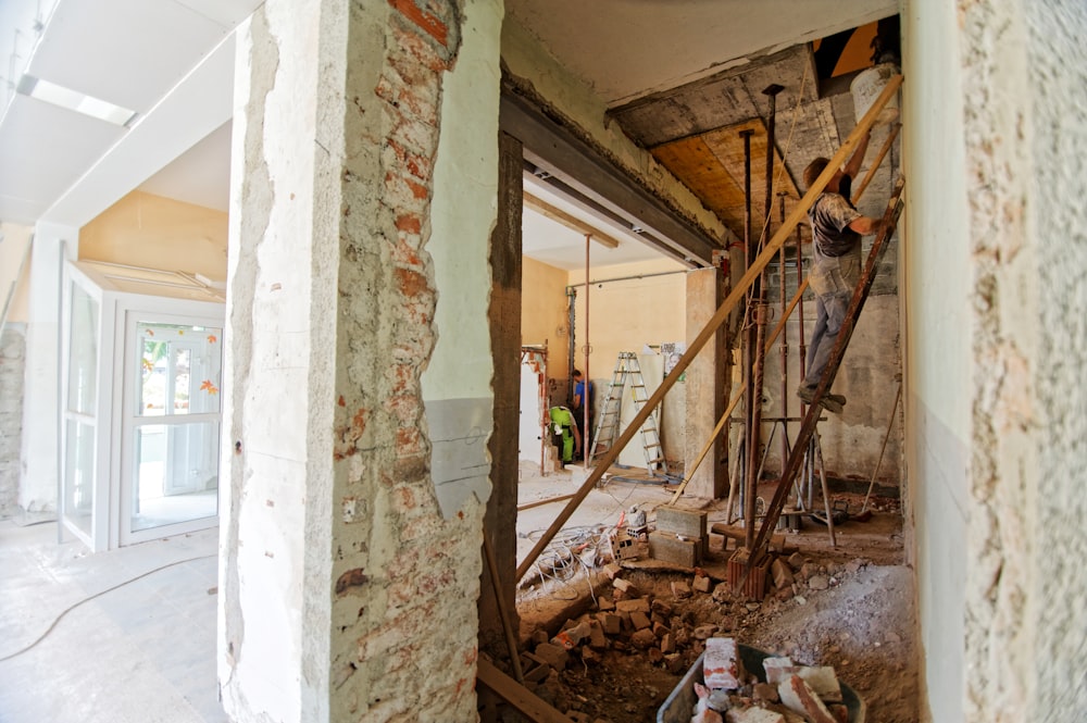 man climbing on ladder inside room