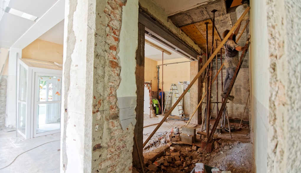 man climbing on ladder inside room