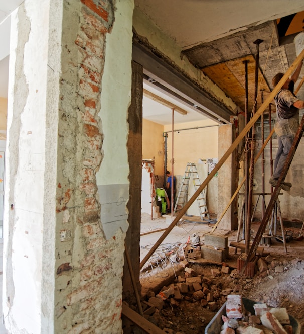 man climbing on ladder inside room