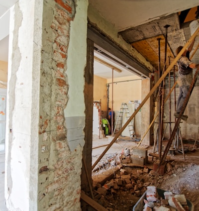 man climbing on ladder inside room