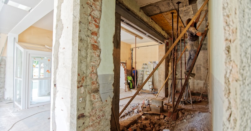 man climbing on ladder inside room