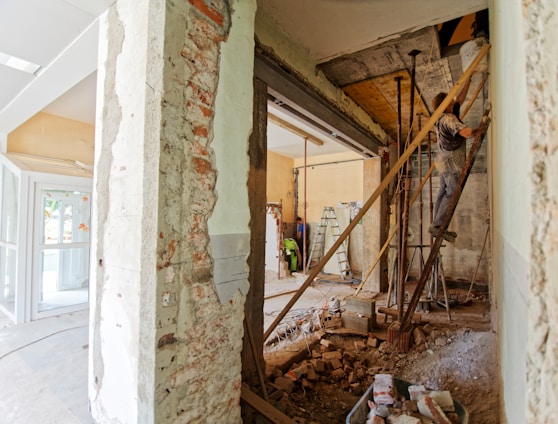 man climbing on ladder inside room