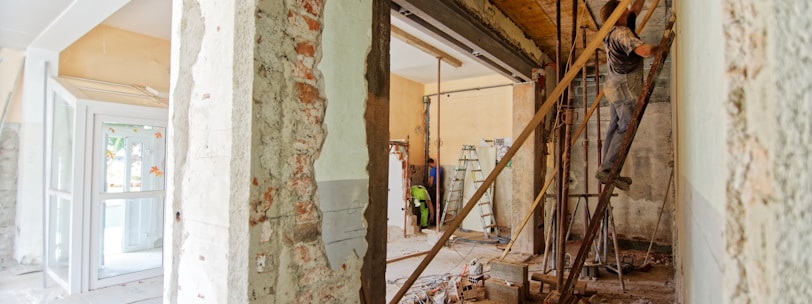 man climbing on ladder inside room