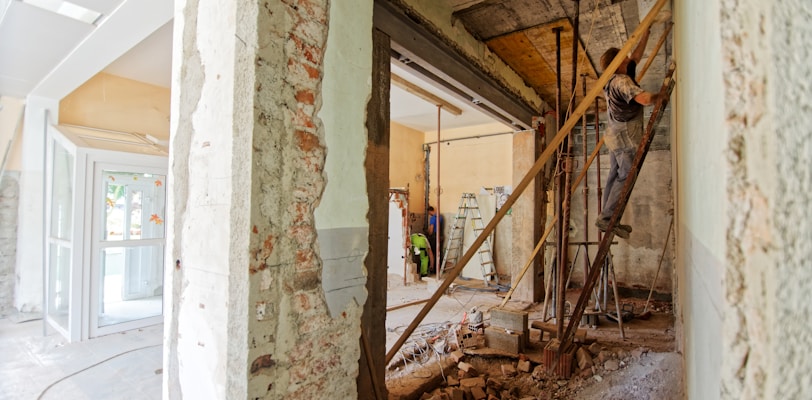 man climbing on ladder inside room