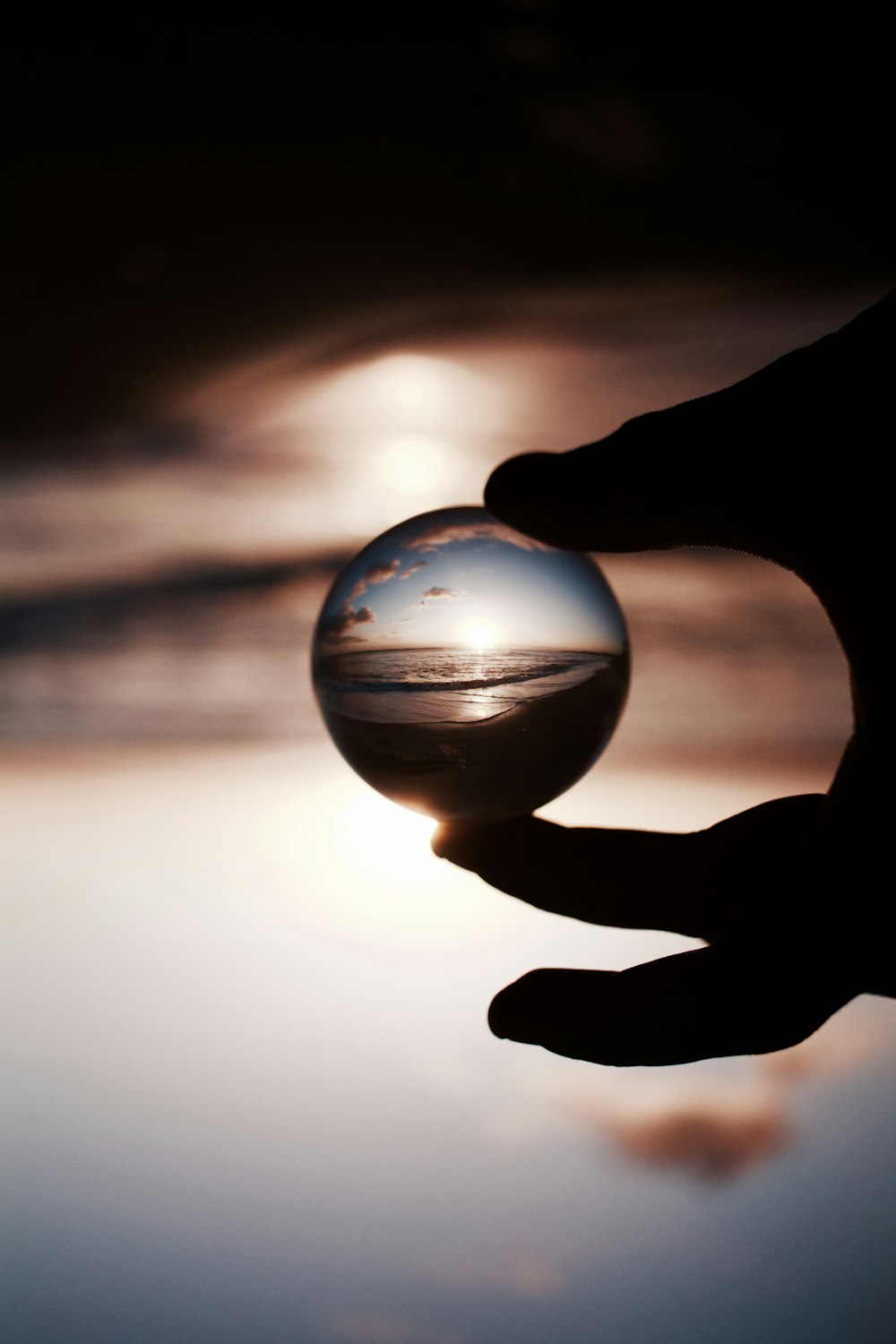 selective focus photography of glass globe with picture of seat