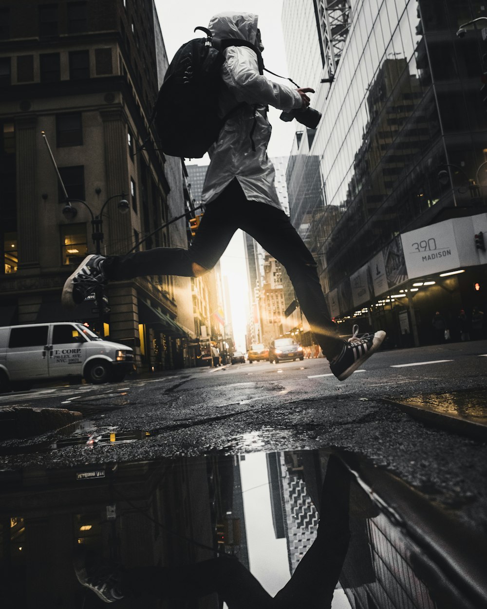 person jumping above puddle of water