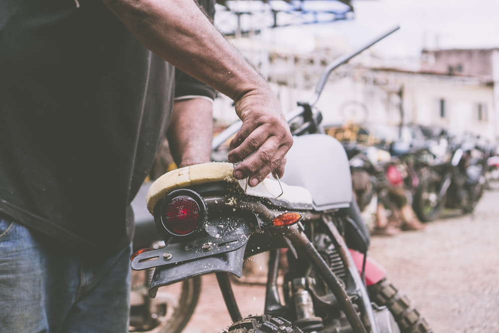 person holding the motorcycle