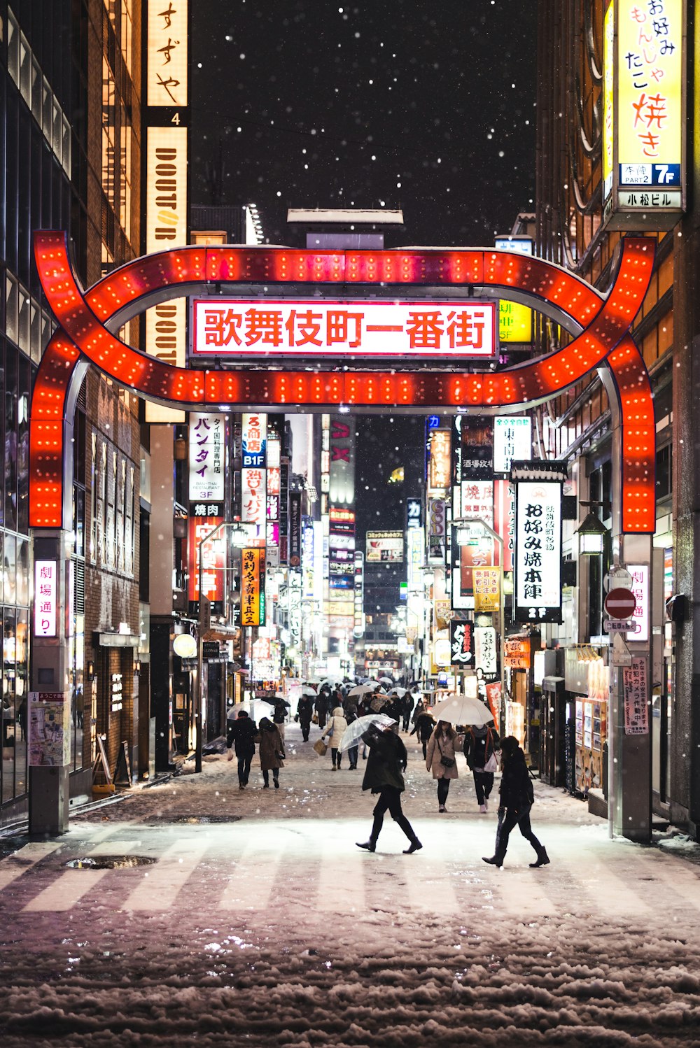 people walking on streets at night