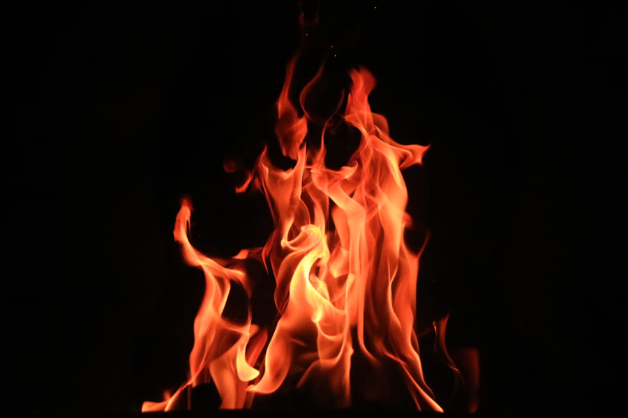 Bright orange flames burning against darkness