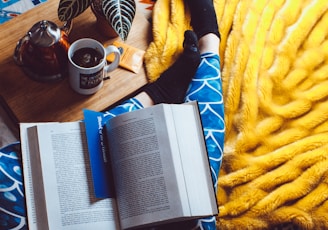 book opened on person's legs