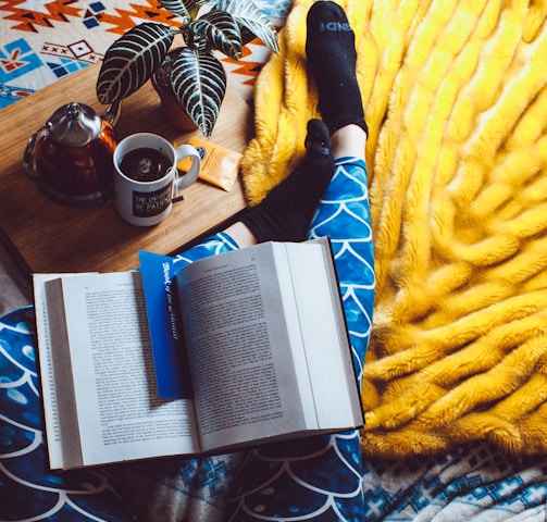 book opened on person's legs