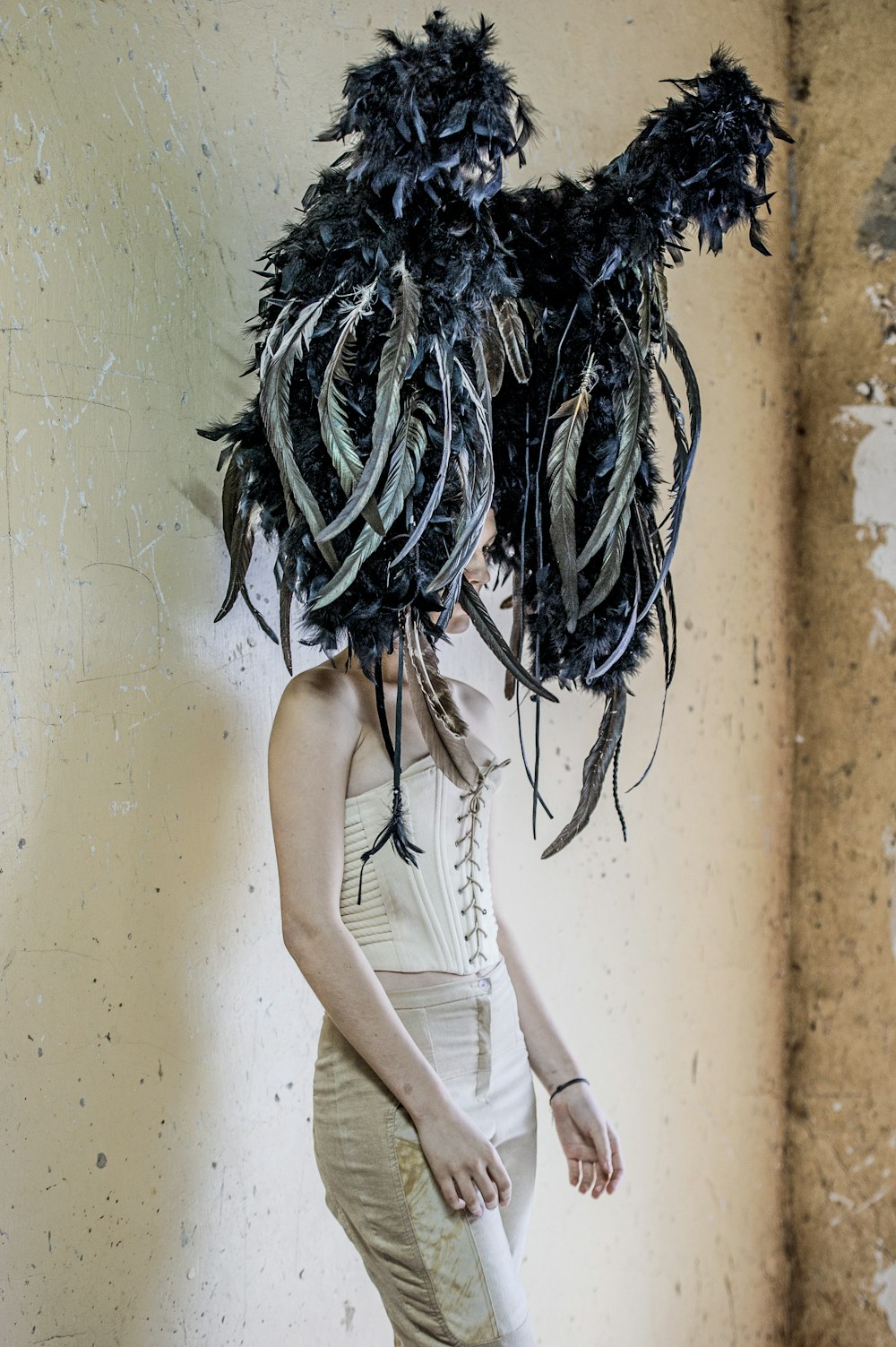 woman in front of the wall wearing traditional costume headdress