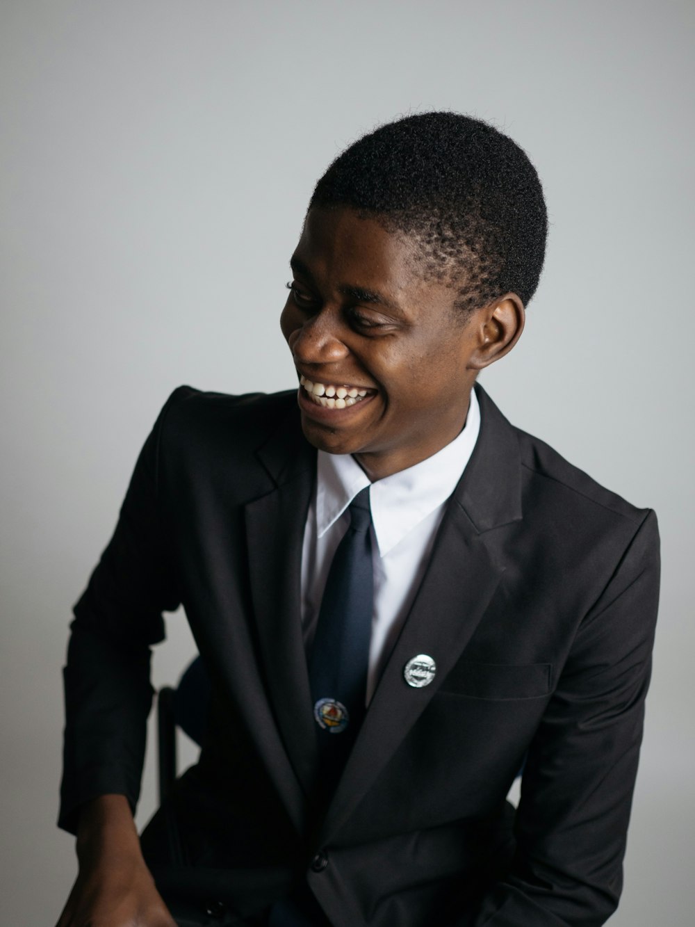 man wearing suit jacket and white painted wall