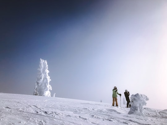 two people standing on mountain covered with snow in Montana United States