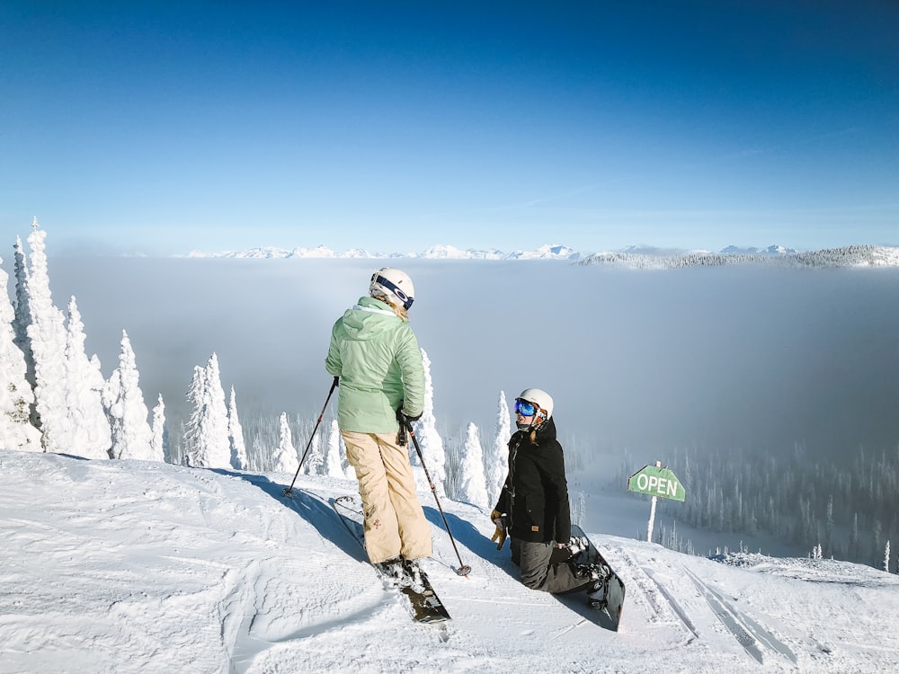 man in green snow jacket and brown pants