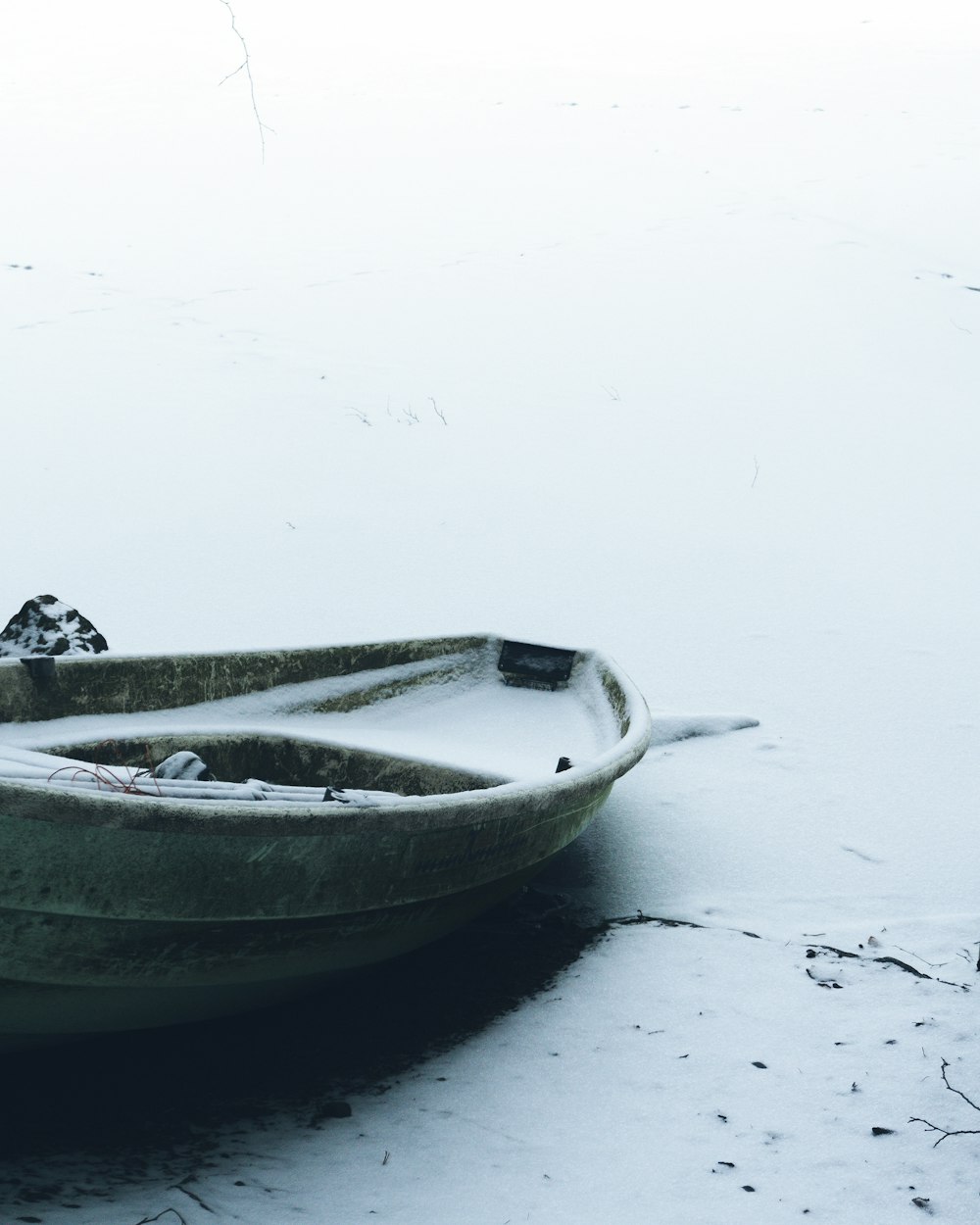 brown canoe boat on icy surface