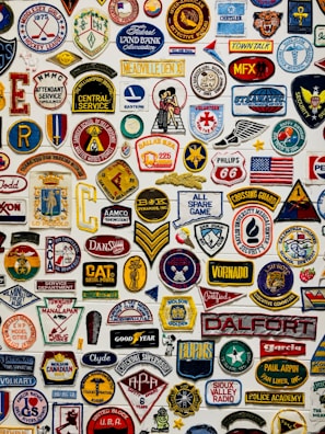 A colorful assortment of embroidered patches displayed on a wooden table.