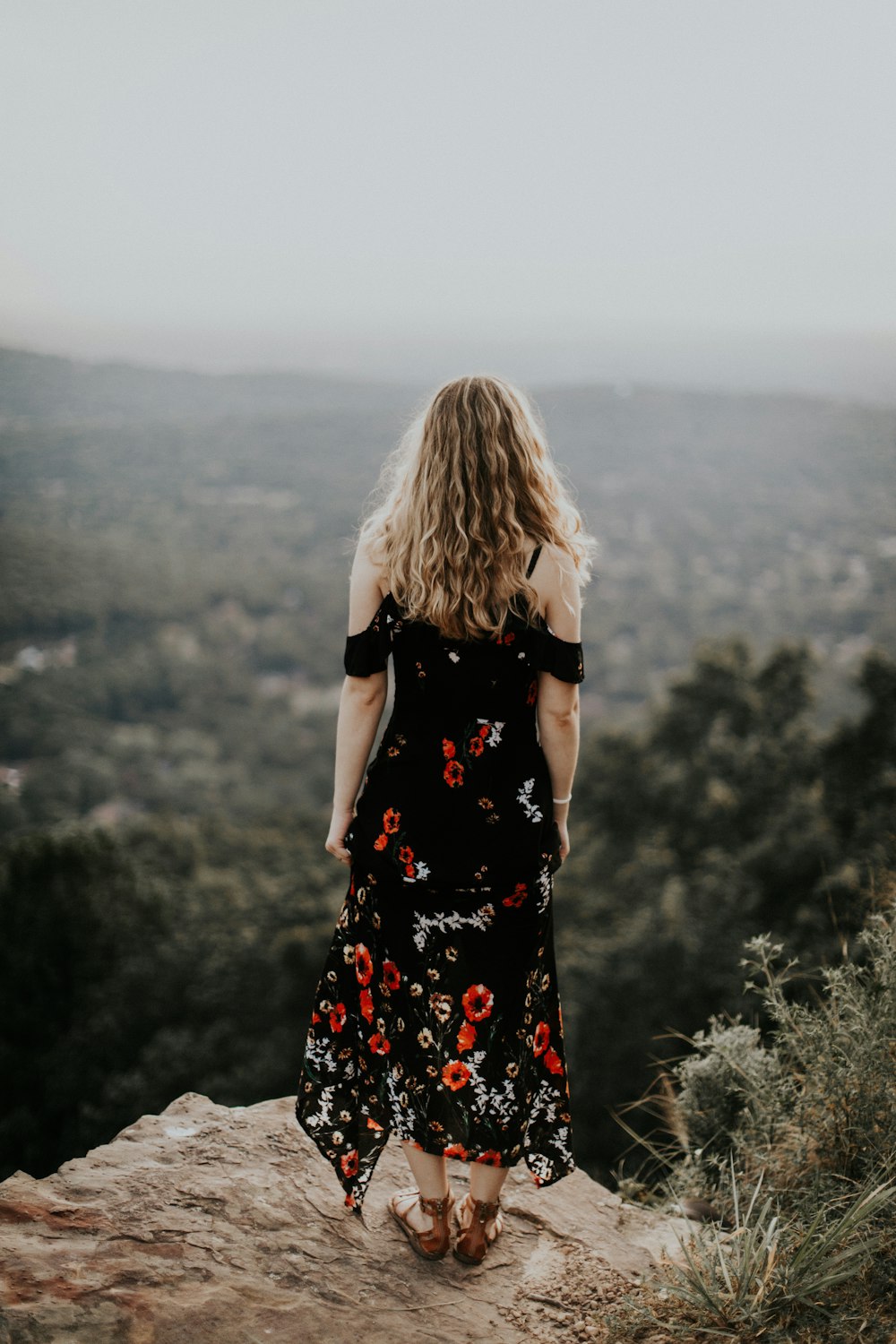 woman standing near the cliff