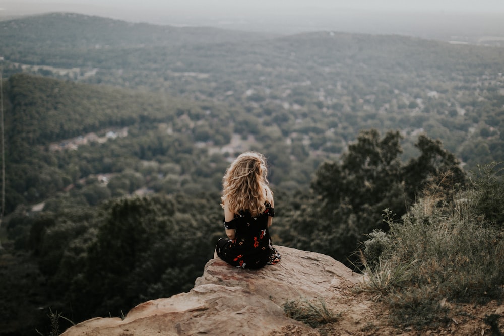 woman siting on cliff