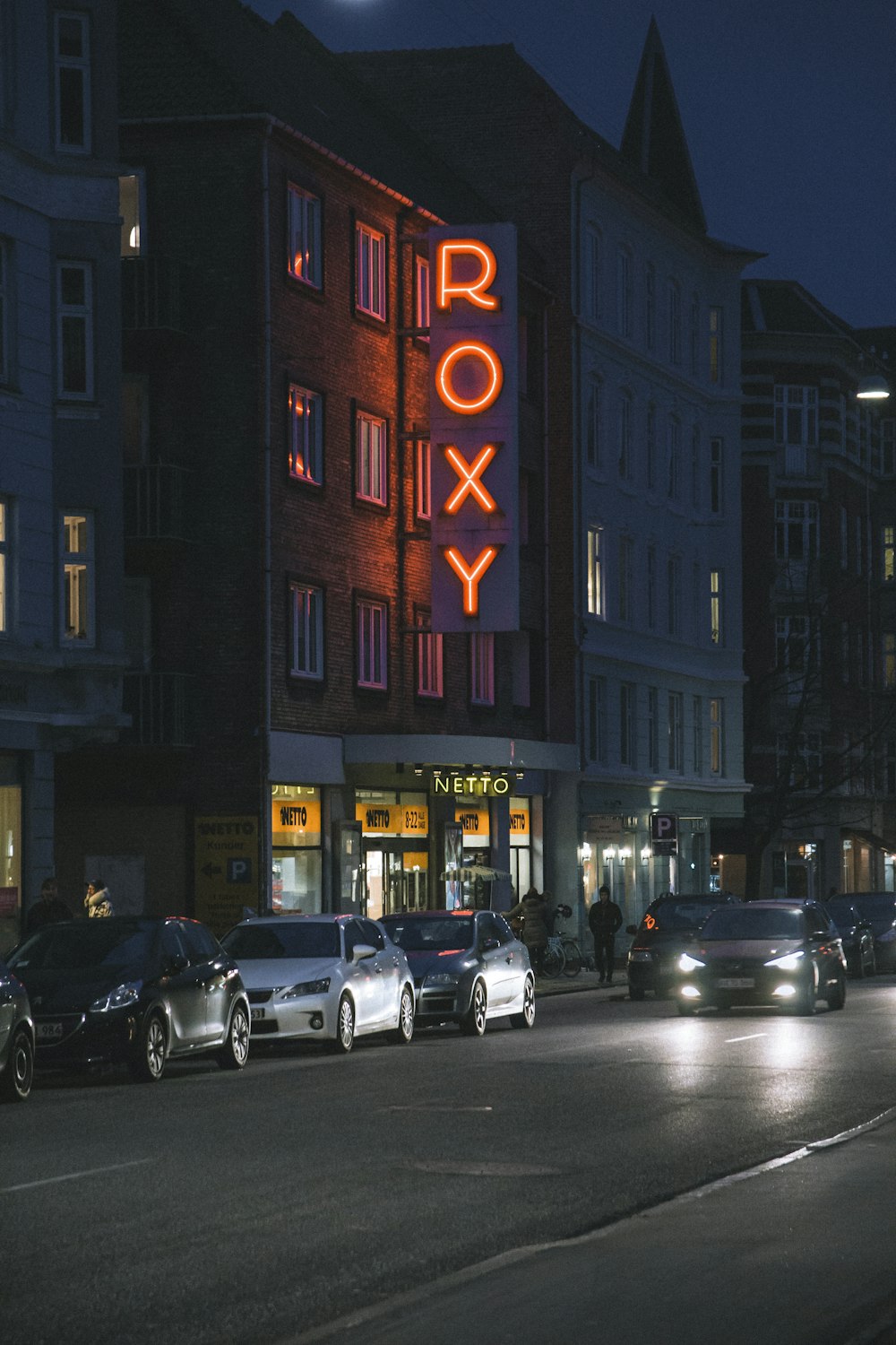 vehicles in front of Roxy establishment during nighttime