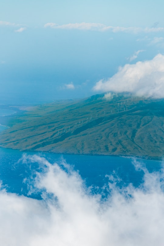 aerial photography of electric windmill on landform in Maui County United States
