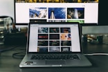 MacBook Pro turned on placed on wooden table