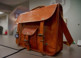 closeup photo of brown leather crossbody bag