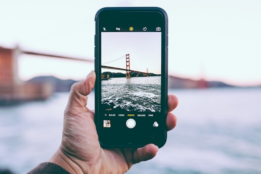 person taking photo of Golden Gate Bridge, California