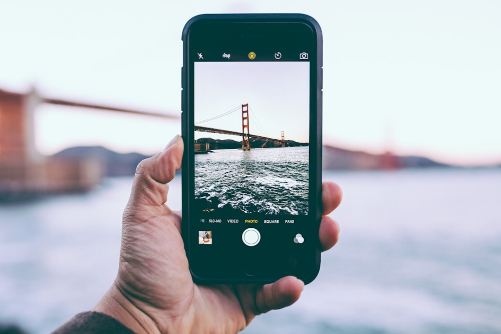 person taking photo of Golden Gate Bridge, California