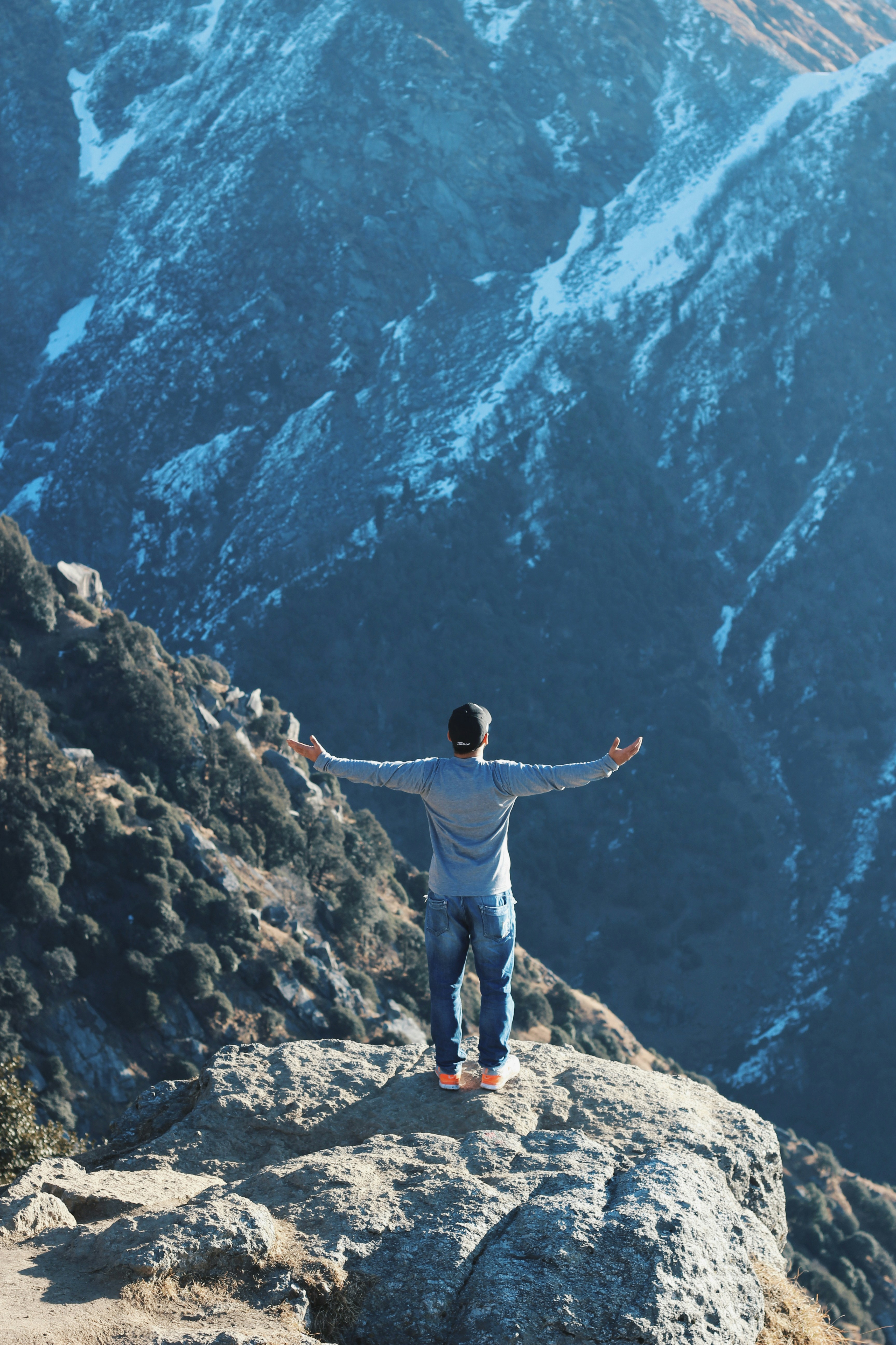 A guy standing on a rock mountain in Triund Trek