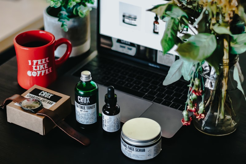 Product bottles beside a laptop in a small e-commerce workspace