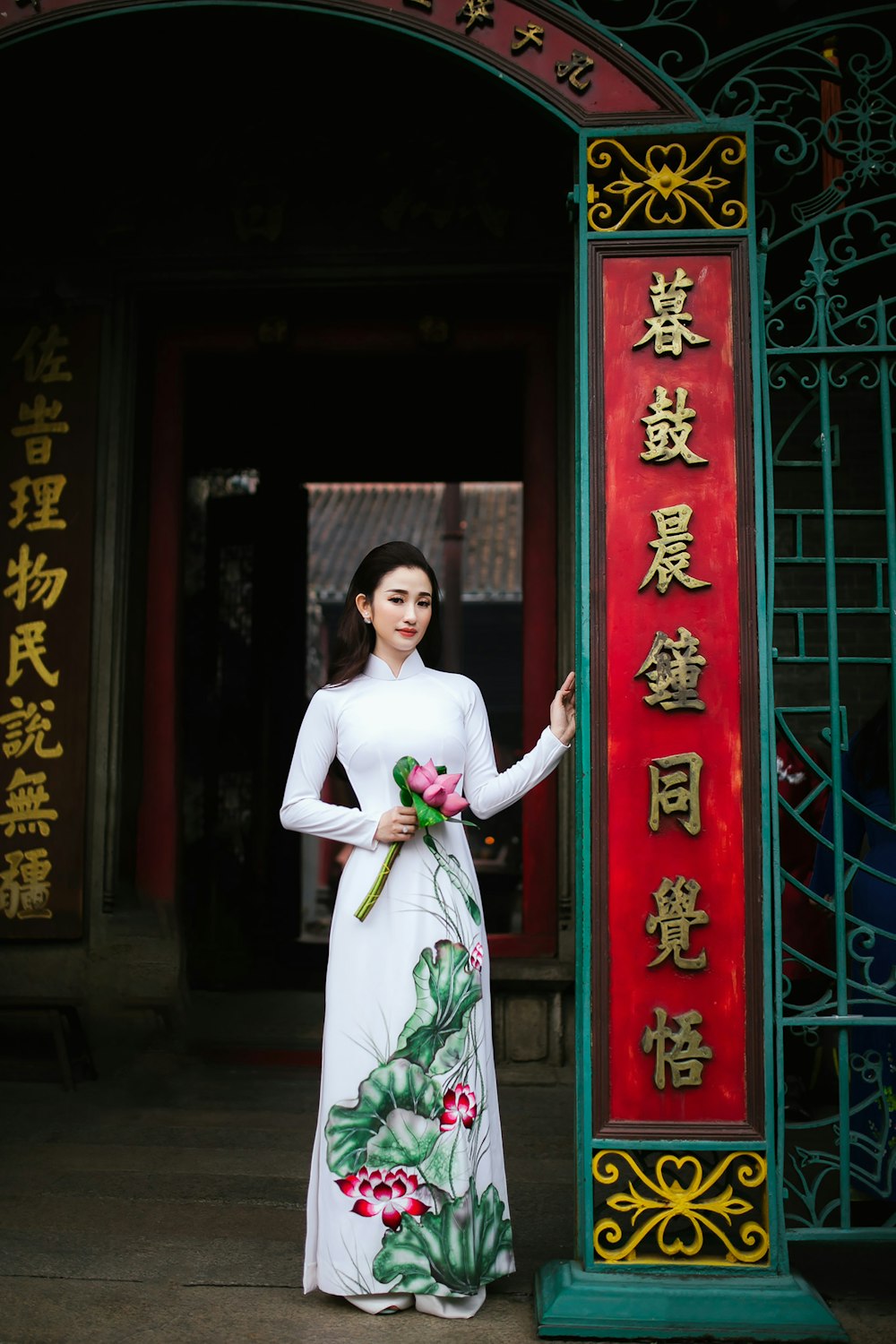 woman standing while holding flowers