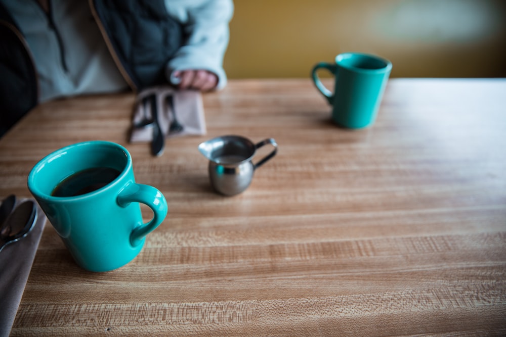 teal ceramic mug on table