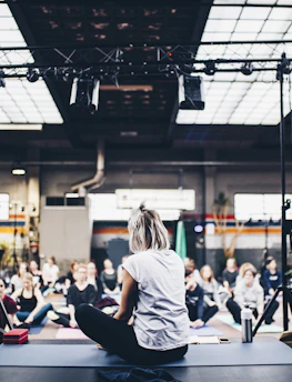 An online yoga therapy session with participants of all ages smiling and engaged.