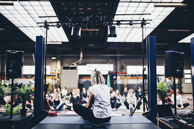 A serene circle of people meditating together in a softly lit room filled with crystals.