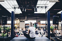 A serene group therapy session in a softly lit natural room with participants sitting quietly in a circle.