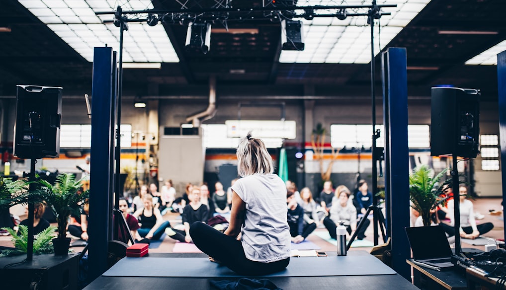 woman sitting in the yoga mat