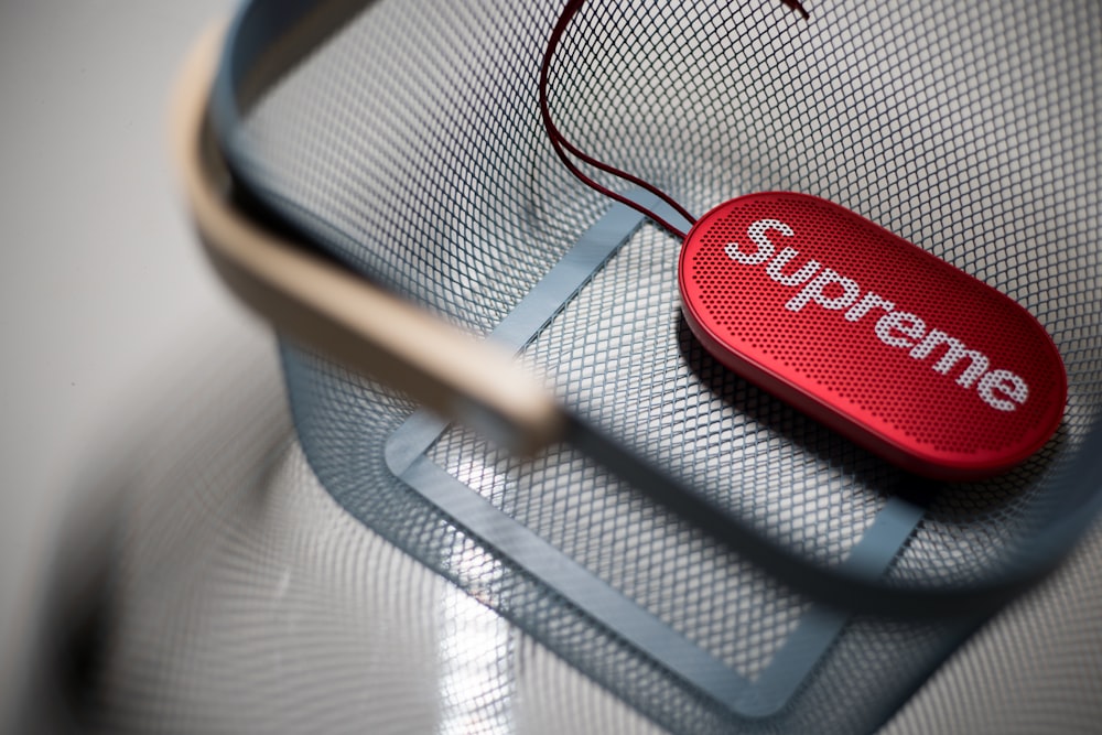 oval red Supreme speaker in blue basket