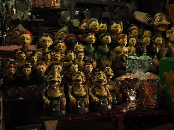 Close-up of colorful handcrafted wooden toys displayed on a wooden shelf.