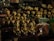 A collection of intricately crafted wooden figurines, each with unique facial expressions and colorful attire, is displayed densely on shelves. Among the figures, there are a variety of handcrafted items and trinkets surrounding them, showcasing a rich assortment of artwork and decor.