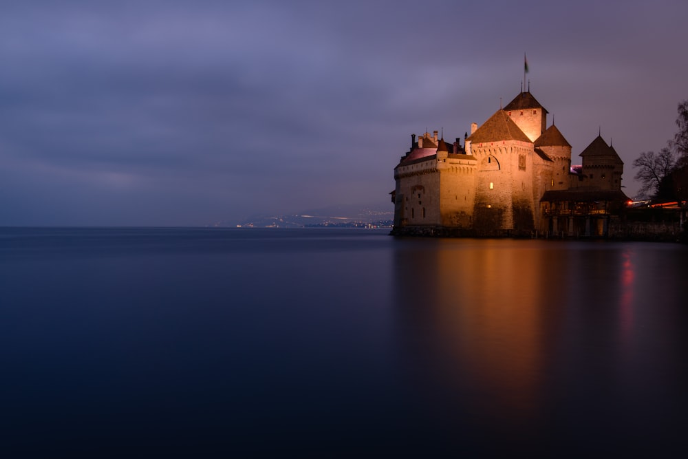 foto do castelo marrom perto do corpo de água