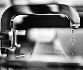 grayscale photography of faucet