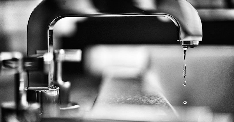 grayscale photography of faucet