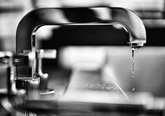 grayscale photography of faucet