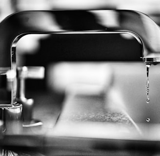 grayscale photography of faucet