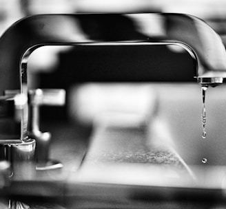 grayscale photography of faucet