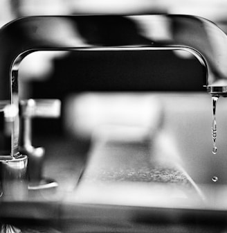 grayscale photography of faucet