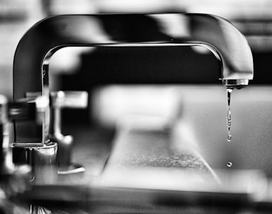 grayscale photography of faucet