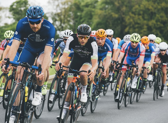 group of cyclist on asphalt road